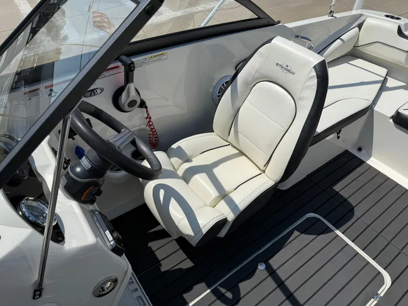 Slide: The Image of 2020 Stingray 191 DC boat interior with steering wheel and cushioned seat. - 15