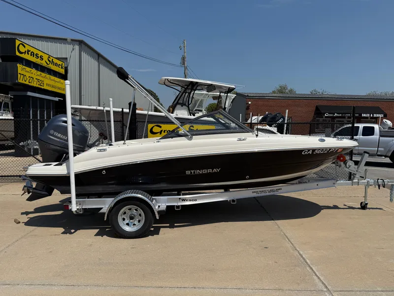Slide: The Image of 2020 Stingray 191 DC boat on trailer, parked outside dealership. - 2