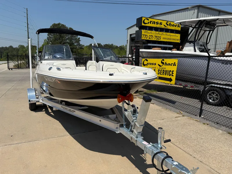 Slide: The Image of 2020 Stingray 191 DC boat on trailer at dealership, sunny day. - 3