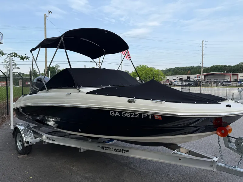 Slide: The Image of 2020 Stingray 191 DC boat on trailer with black canopy and cover. - 37
