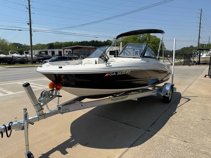 Slide: The Image of 2020 Stingray 191 DC boat on trailer, parked outdoors, sunny day. - 4