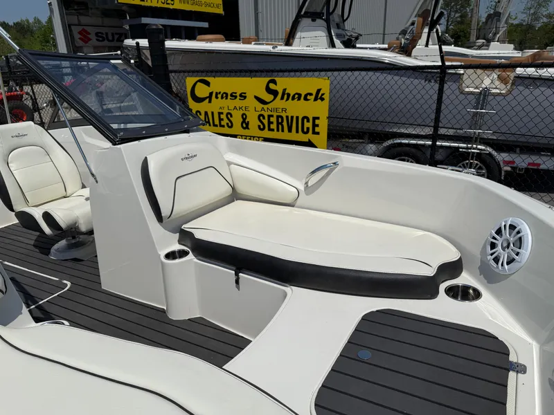 Slide: The Image of 2020 Stingray 191 DC boat interior with seating, displayed at a sales and service center. - 8