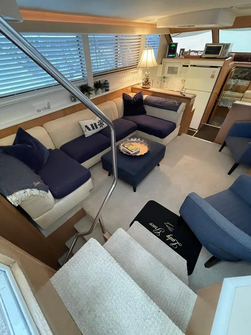 Slide: The Image of Luxurious interior of a 1995 Hatteras 52 Motor Yacht with cozy seating and elegant decor. - 10