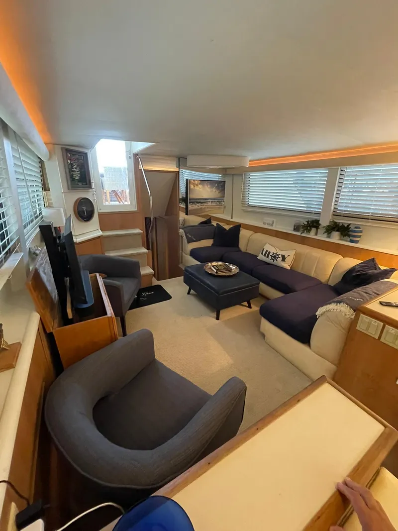 Slide: The Image of Luxurious interior of 1995 Hatteras 52 Motor Yacht with cozy seating and modern decor. - 11