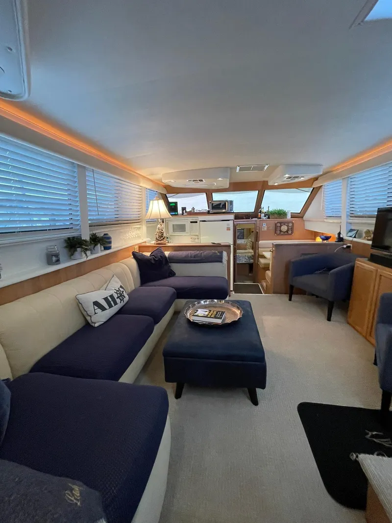 Slide: The Image of Luxurious interior of a 1995 Hatteras 52 Motor Yacht with elegant seating and decor. - 12