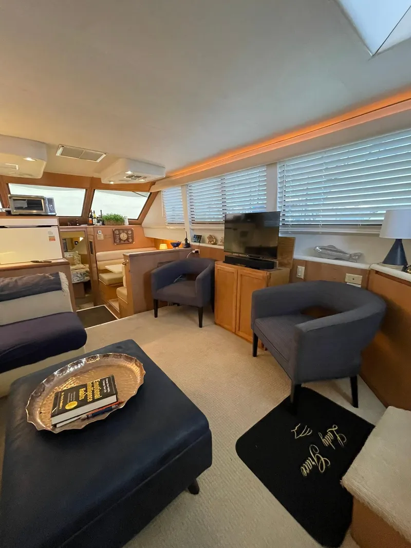 Slide: The Image of Interior of 1995 Hatteras 52 Motor Yacht with cozy seating and modern amenities. - 13