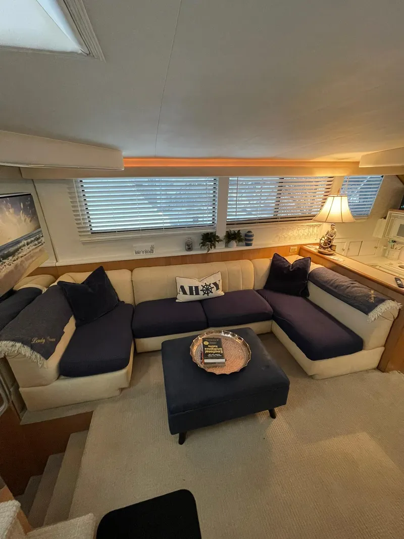 Slide: The Image of Luxurious interior of a 1995 Hatteras 52 Motor Yacht with cozy seating and elegant decor. - 14