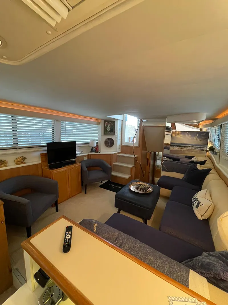 Slide: The Image of Luxurious interior of 1995 Hatteras 52 Motor Yacht with cozy seating and modern amenities. - 15