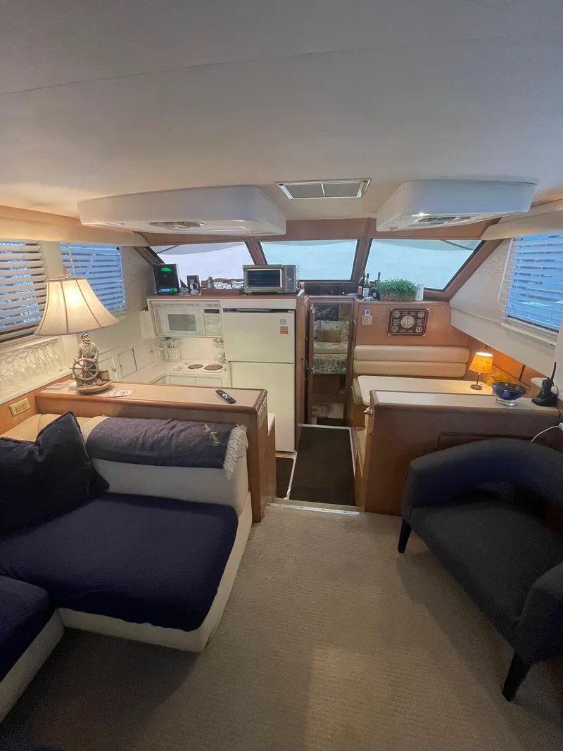 Slide: The Image of Interior of 1995 Hatteras 52 Motor Yacht, featuring cozy seating and modern amenities. - 17