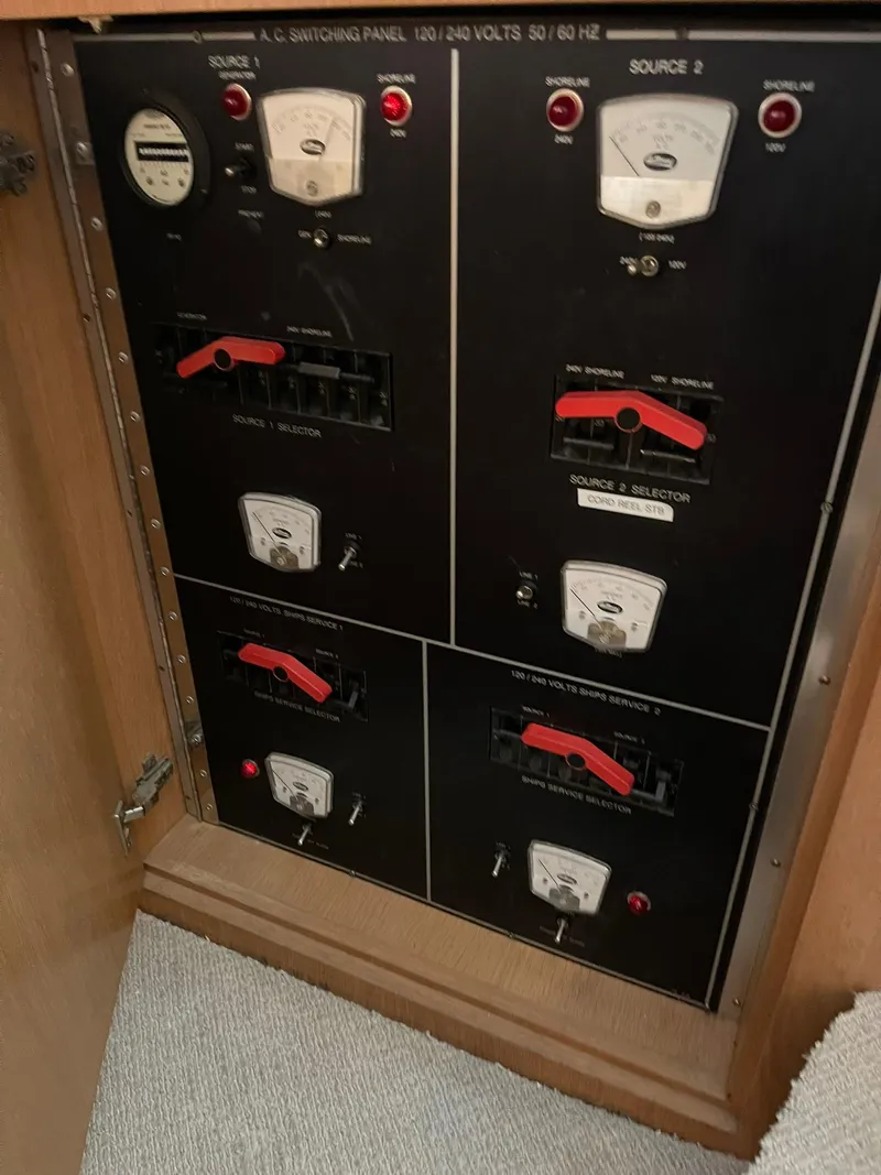 Slide: The Image of Electrical panel on a 1995 Hatteras 52 Motor Yacht, featuring voltage meters and switches. - 21