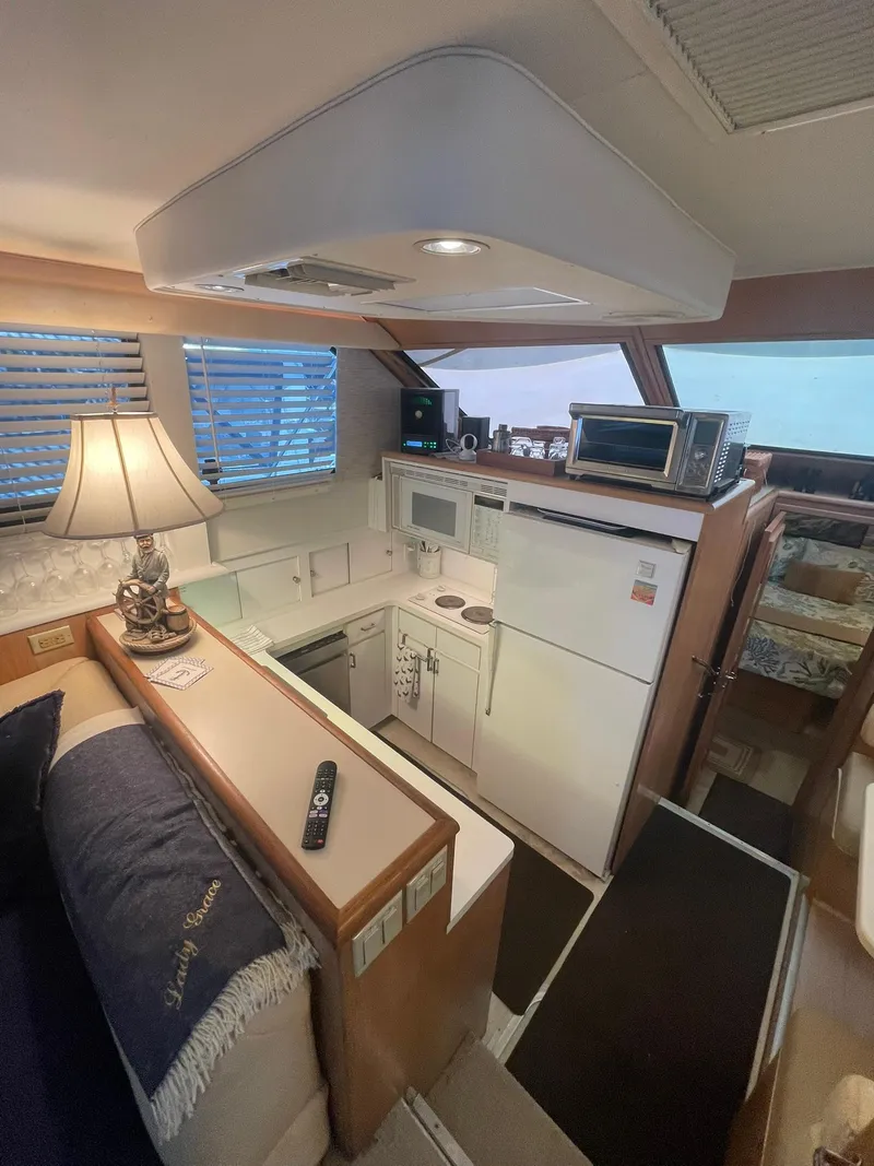 Slide: The Image of Interior of 1995 Hatteras 52 Motor Yacht with kitchen and cozy seating area. - 27