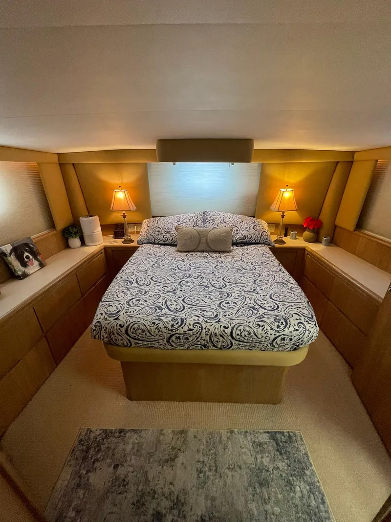 Slide: The Image of Luxurious bedroom interior of 1995 Hatteras 52 Motor Yacht with elegant bedding and warm lighting. - 37