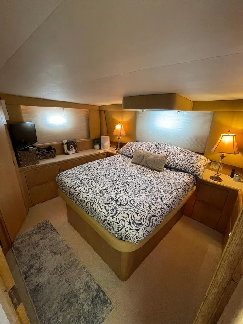 Slide: The Image of Cozy bedroom in 1995 Hatteras 52 Motor Yacht with elegant bedding and warm lighting. - 38