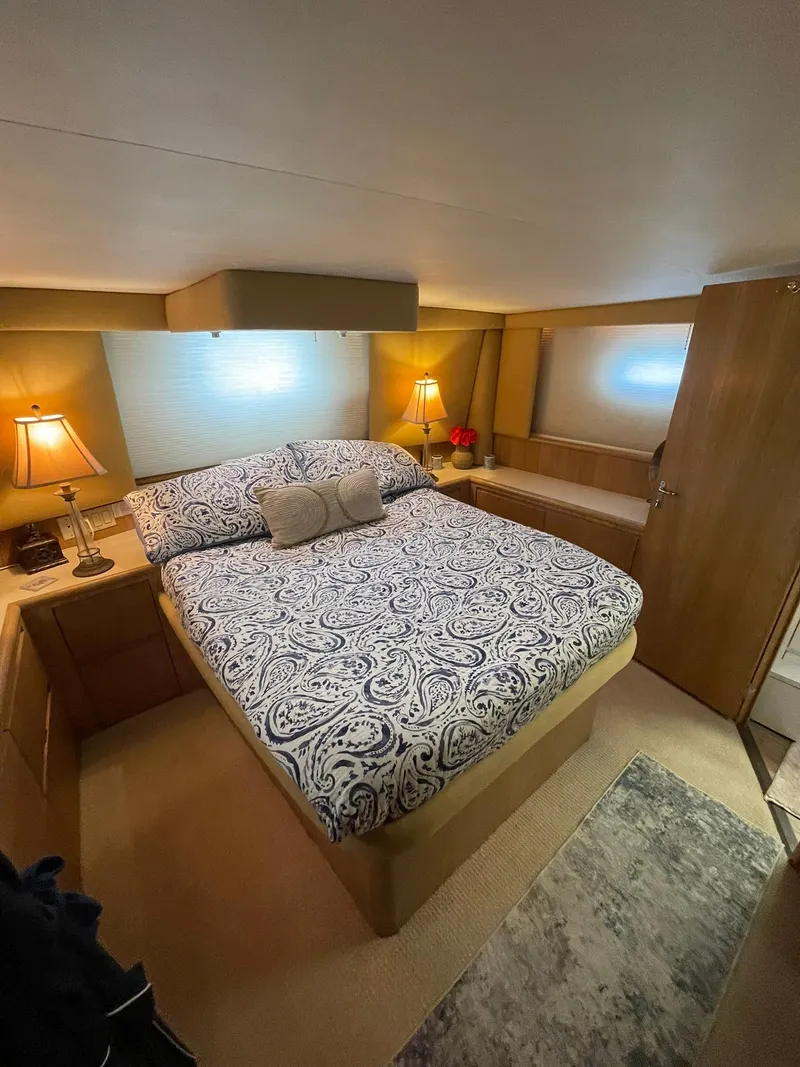 Slide: The Image of Luxurious bedroom interior of 1995 Hatteras 52 Motor Yacht with elegant bedding and warm lighting. - 39