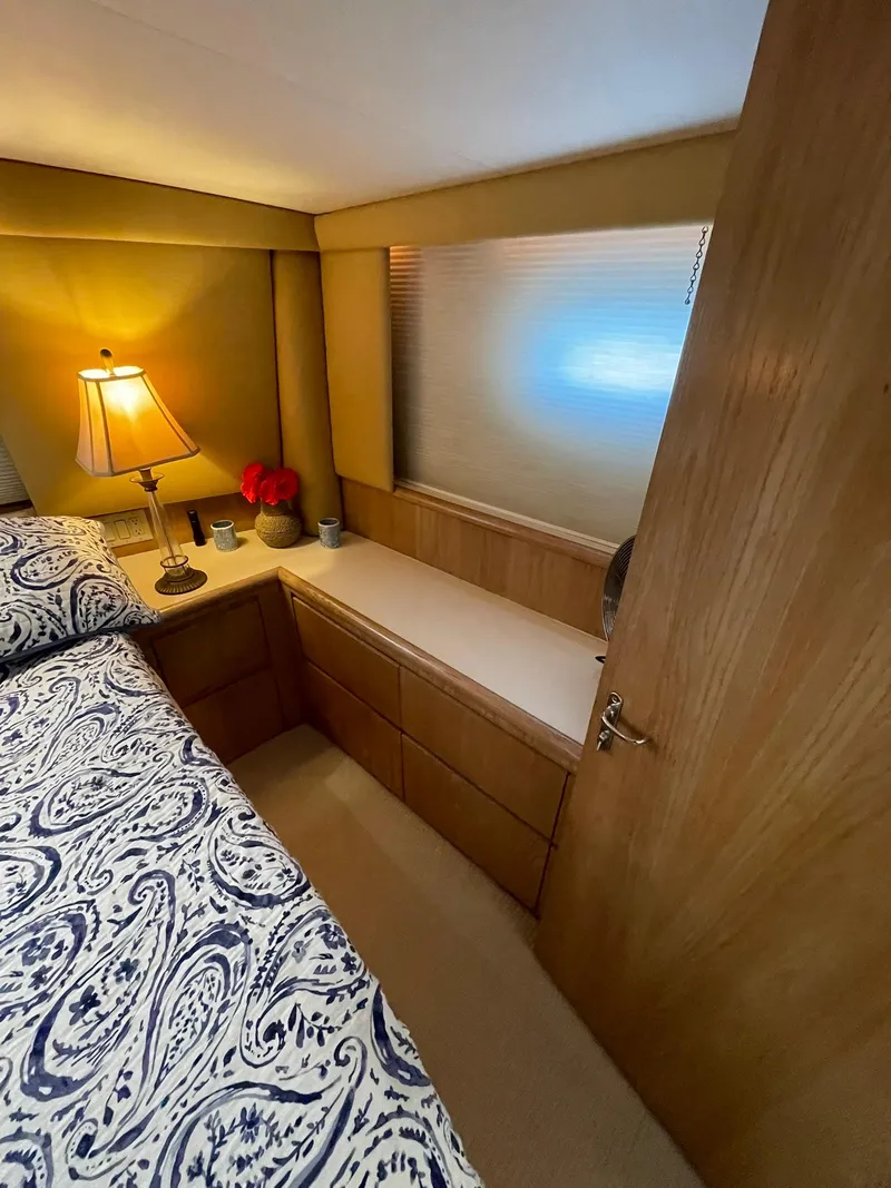 Slide: The Image of Cozy bedroom in 1995 Hatteras 52 Motor Yacht with elegant decor and soft lighting. - 41