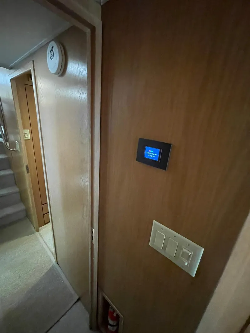 Slide: The Image of Interior of 1995 Hatteras 52 Motor Yacht with wooden paneling and control panel. - 42