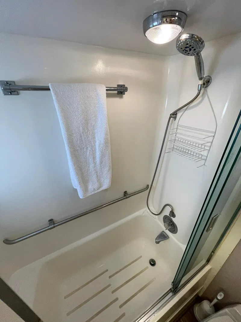 Slide: The Image of Shower area in 1995 Hatteras 52 Motor Yacht with towel and showerhead. - 45