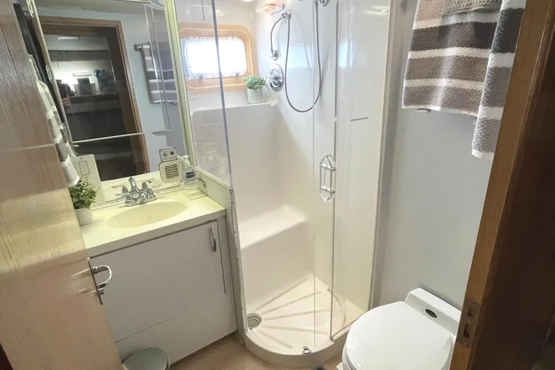 Slide: The Image of Bathroom interior of 1995 Hatteras 52 Motor Yacht with shower, sink, and toilet. - 49