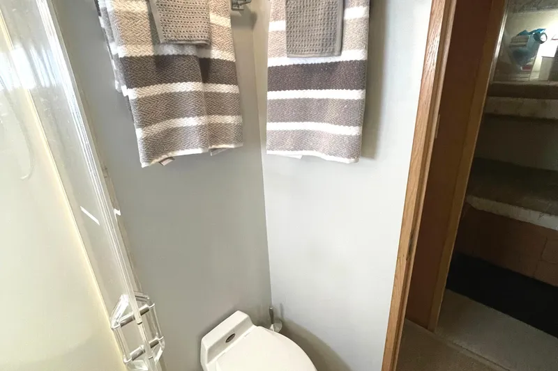 Slide: The Image of Bathroom interior of 1995 Hatteras 52 Motor Yacht with striped towels and shower. - 51