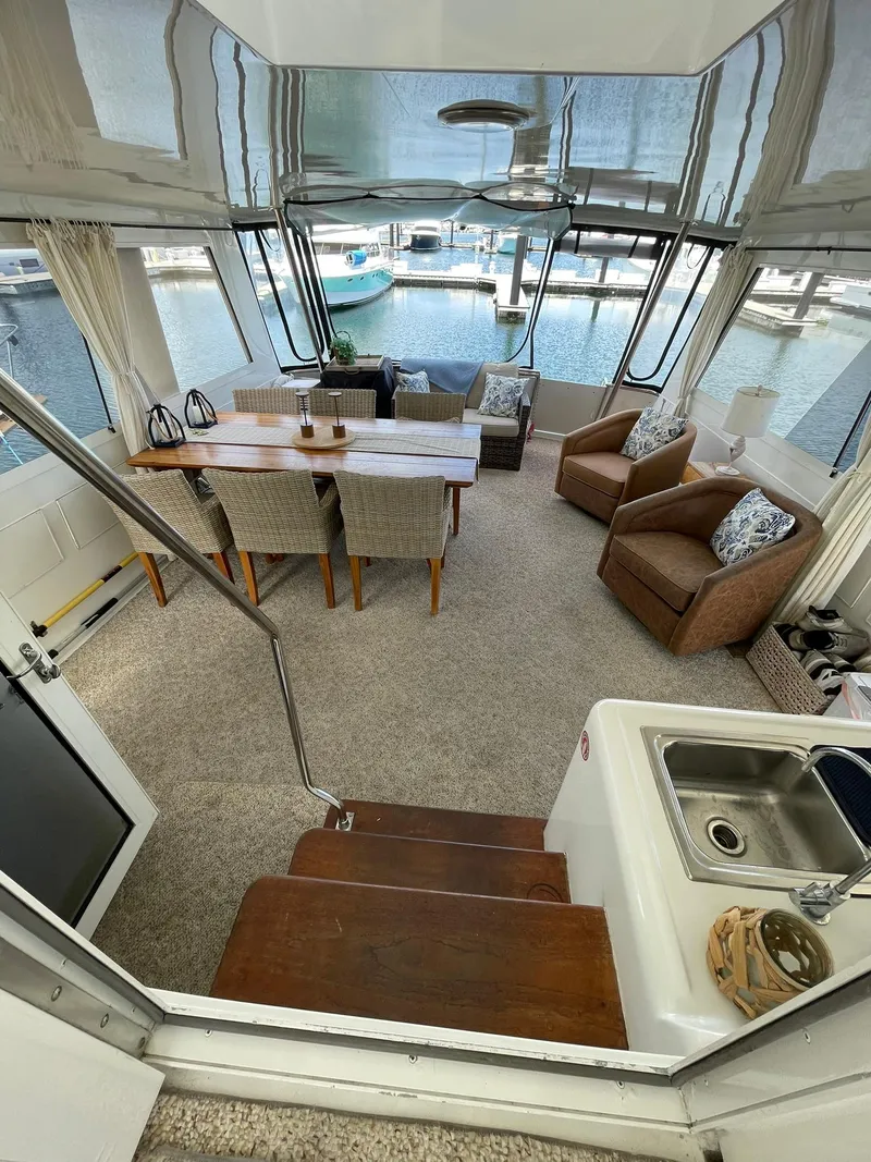 Slide: The Image of Luxurious interior of a 1995 Hatteras 52 Motor Yacht with elegant seating and dining area. - 53