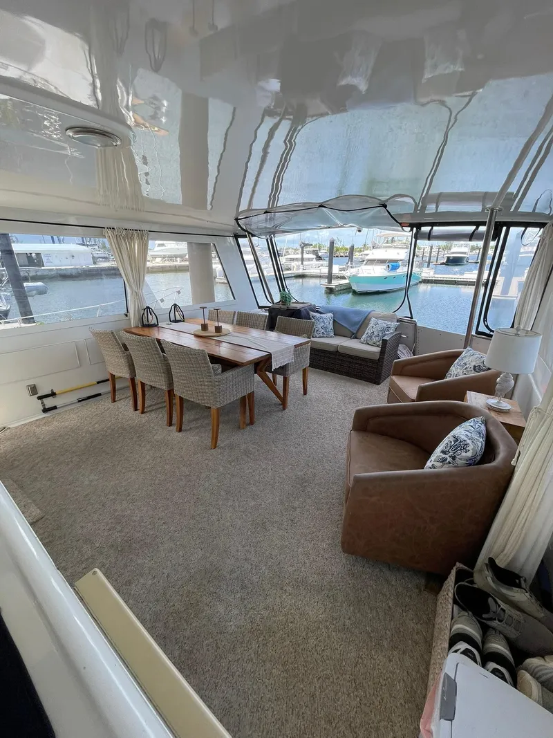 Slide: The Image of Luxurious interior of 1995 Hatteras 52 Motor Yacht with elegant seating and dining area. - 54