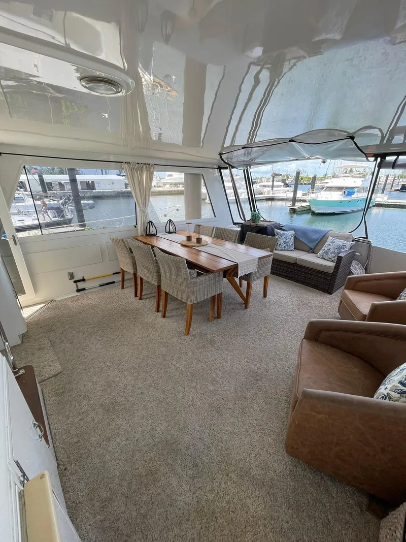 Slide: The Image of Spacious interior of 1995 Hatteras 52 Motor Yacht with elegant dining and seating area. - 55