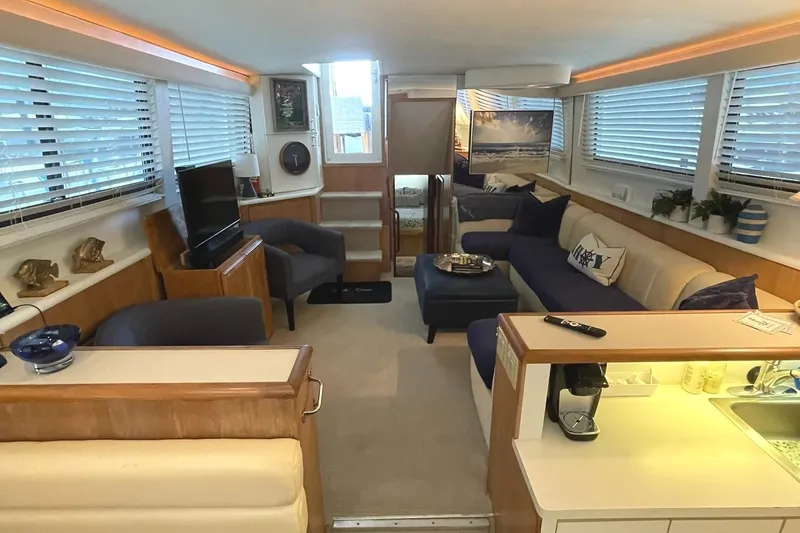 Slide: The Image of Luxurious interior of a 1995 Hatteras 52 Motor Yacht with elegant seating and decor. - 8