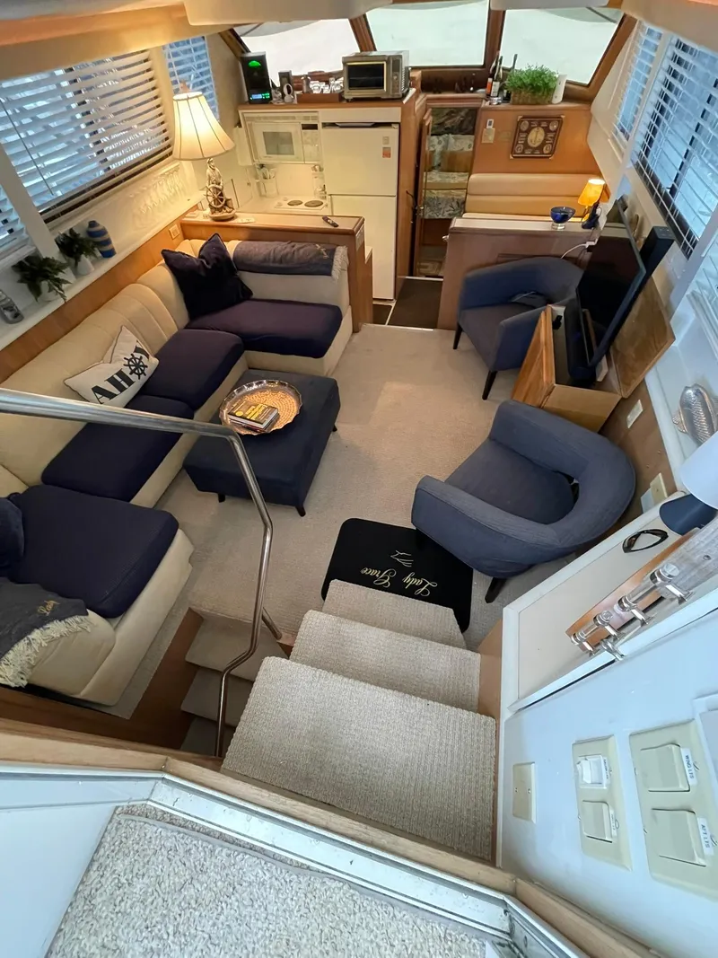 Slide: The Image of Luxurious interior of a 1995 Hatteras 52 Motor Yacht with cozy seating and elegant decor. - 9