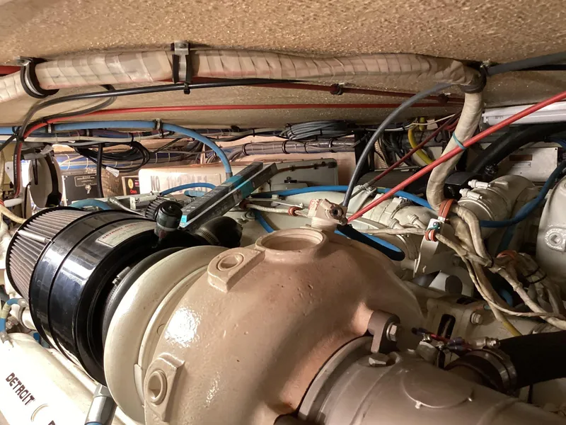 Slide: The Image of Engine room of a 1995 Hatteras 52 Motor Yacht with visible wiring and components. - 98