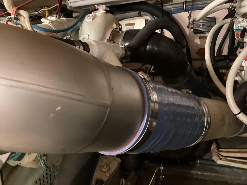 Slide: The Image of Engine room of 1995 Hatteras 52 Motor Yacht, showing exhaust system and piping. - 99