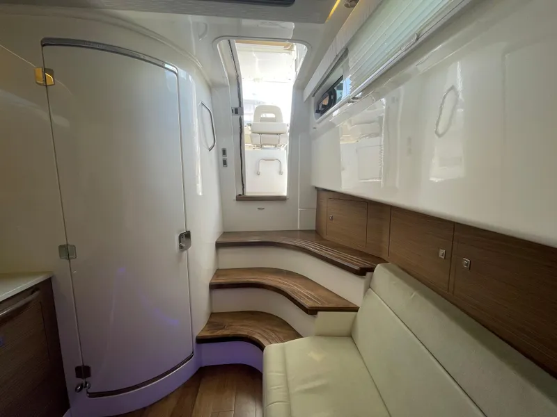 Slide: The Image of Interior of 2017 Boston Whaler 420 Outrage, featuring sleek design and wooden accents. - 12