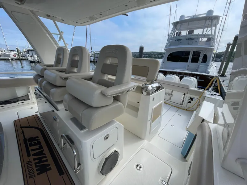 Slide: The Image of 2017 Boston Whaler 420 Outrage interior with luxurious seating and marina view. - 14