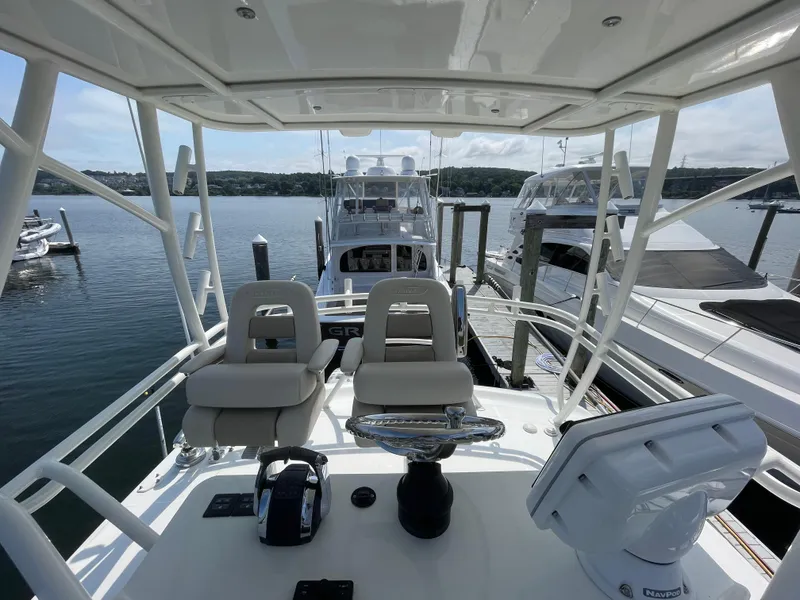 Slide: The Image of Boston Whaler 420 Outrage 2017 helm view, docked with other boats in marina. - 24