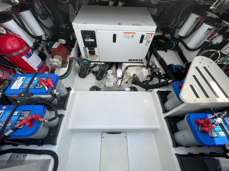Slide: The Image of Engine room of 2017 Boston Whaler 420 Outrage with Kohler generator and batteries. - 25