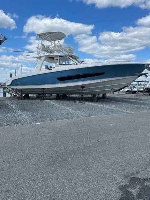Slide: The Image of 2017 Boston Whaler 420 Outrage boat on display under a blue sky. - 26