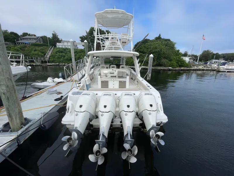 Slide: The Image of 2017 Boston Whaler 420 Outrage with four engines docked at marina. - 3