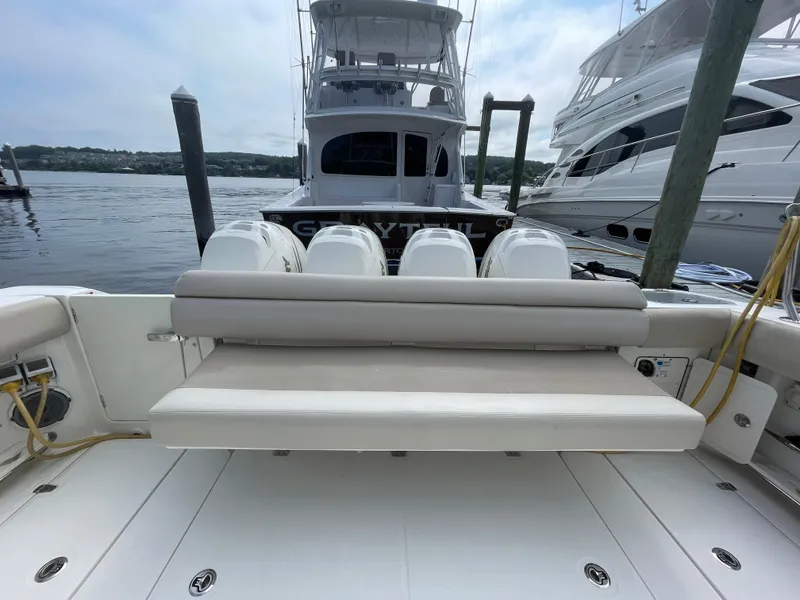 Slide: The Image of 2017 Boston Whaler 420 Outrage boat docked, featuring spacious seating and powerful engines. - 4