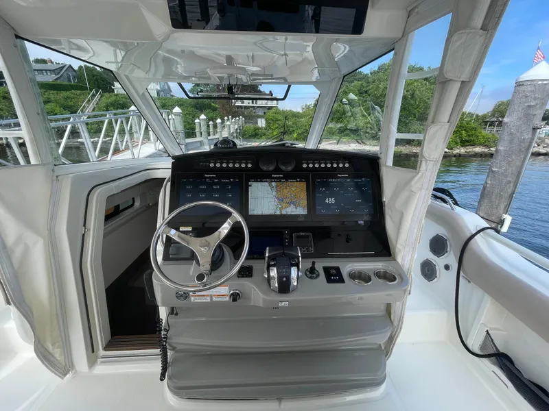 Slide: The Image of 2017 Boston Whaler 420 Outrage helm with advanced navigation displays and steering wheel. - 7