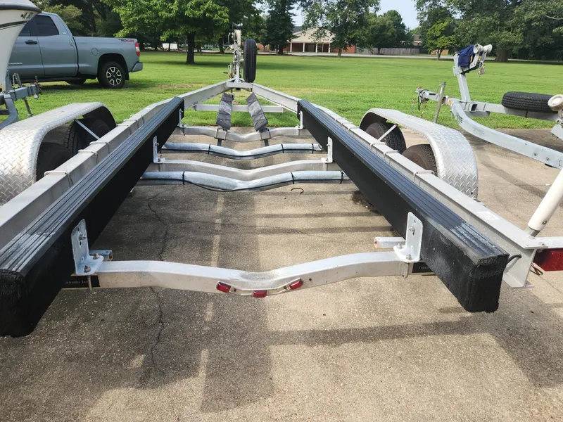 Slide: The Image of Boat trailer for 2005 McKee Craft Freedom 22 CC on concrete driveway. - 23