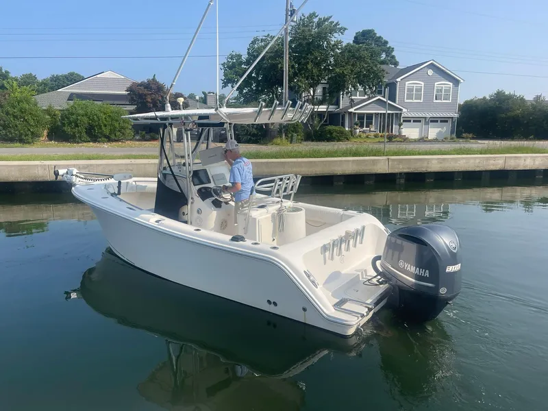 Slide: The Image of 2005 McKee Craft Freedom 22 CC boat on calm water near residential area. - 30