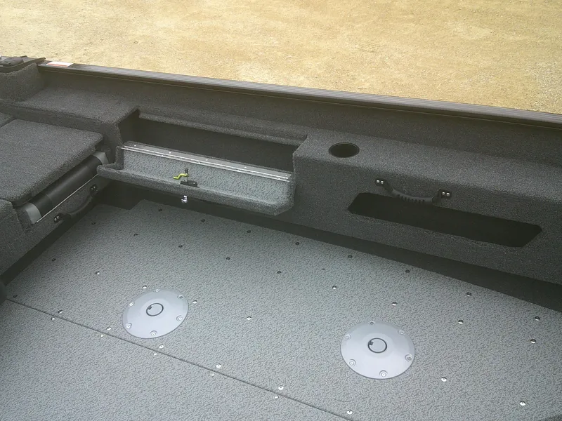 Slide: The Image of 2025 Lund 1775 Adventure SS boat interior with storage compartments and gray flooring. - 12