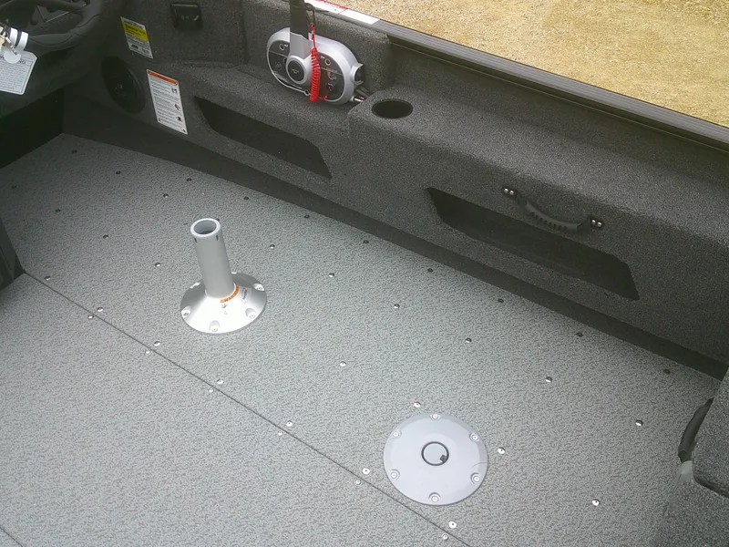 Slide: The Image of 2025 Lund 1775 Adventure SS boat interior with gray flooring and seat mount. - 13