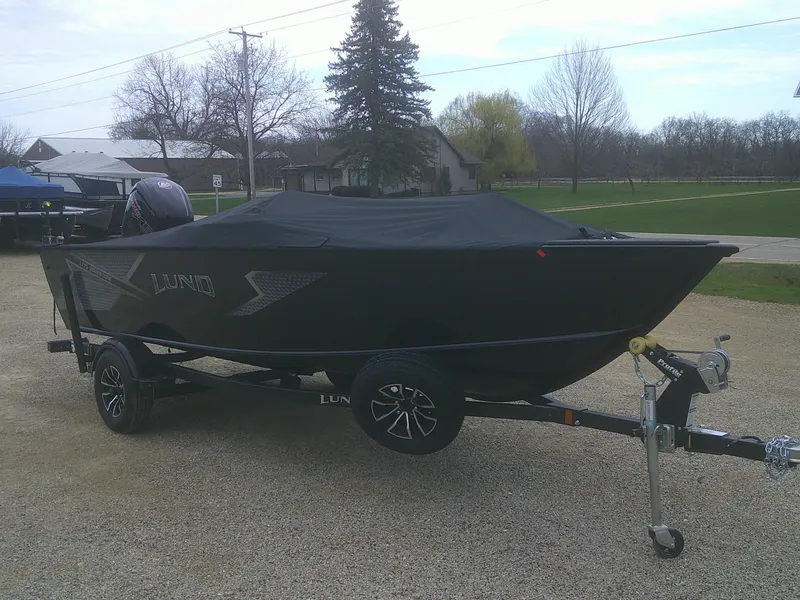 Slide: The Image of 2025 Lund 1775 Adventure SS boat on trailer, covered, parked outdoors. - 14