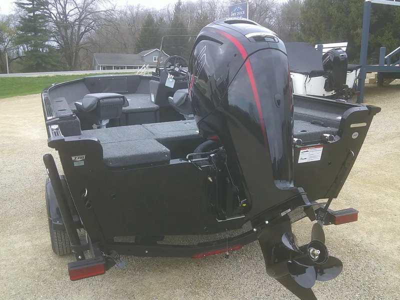 Slide: The Image of 2025 Lund 1775 Adventure SS boat with powerful outboard motor, parked on gravel. - 3