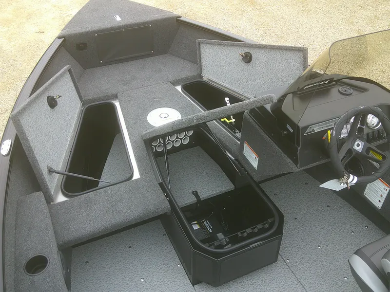 Slide: The Image of 2025 Lund 1775 Adventure SS boat interior with open storage compartments and steering console. - 5