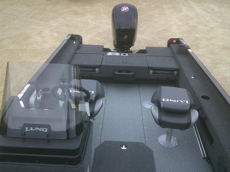 Slide: The Image of 2025 Lund 1775 Adventure SS boat interior with seating and motor, designed for fishing and recreation. - 6