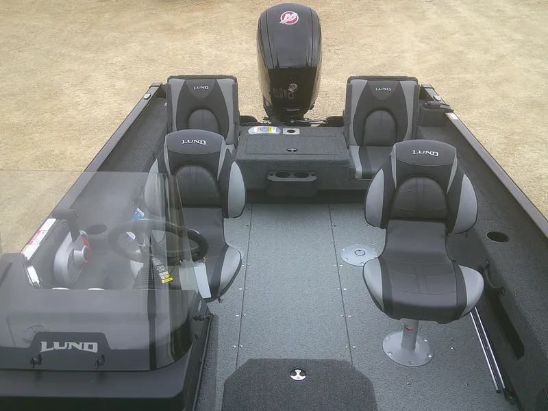 Slide: The Image of 2025 Lund 1775 Adventure SS boat interior with four seats and motor. - 7