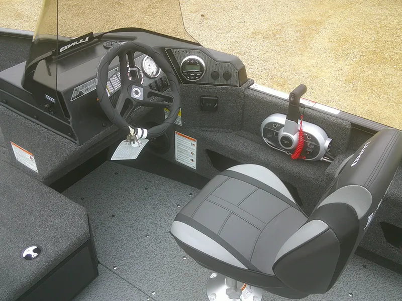 Slide: The Image of 2025 Lund 1775 Adventure SS boat interior with steering wheel and control panel. - 8