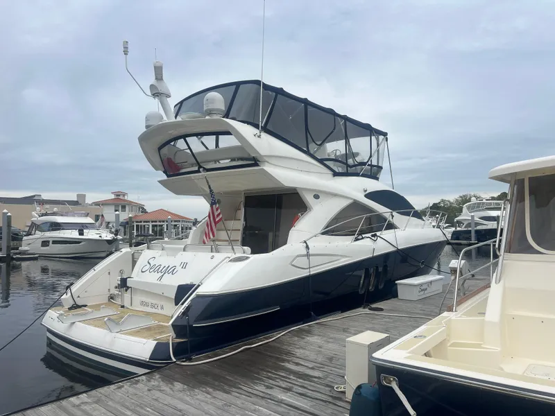 Slide: The Image of 2008 Sunseeker Manhattan 50 yacht docked at marina, featuring sleek design and spacious flybridge. - 1
