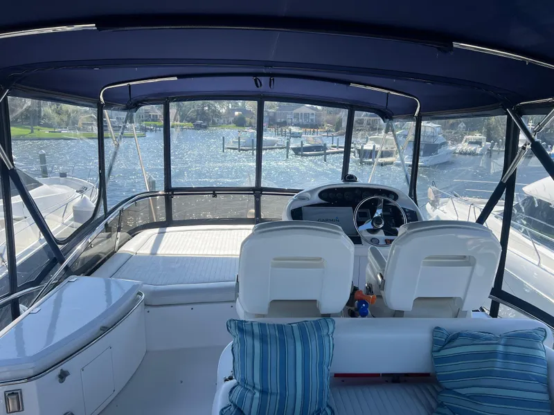 Slide: The Image of 2008 Sunseeker Manhattan 50 yacht interior with helm, seating, and waterfront view. - 10